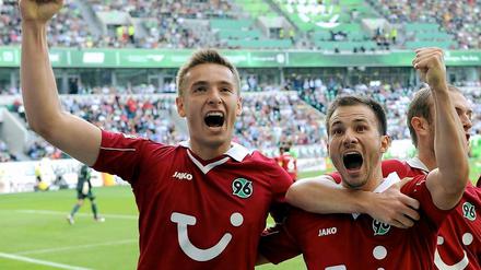 Doppeltorschütze Artur Sobiech (l) bejubelt seinen Treffer zum 0:2 gegen VfL Wolfsburg mit Vorlagengeber Szabolcs Huszti und Konstantin Rausch (r).