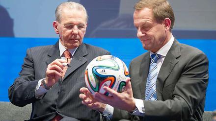Mit den Größten am Ball. In seinem neuen Amt als DOSB-Präsident trifft Alfons Hörmann (r.) auf die wichtigsten Entscheidungsträger der internationalen Sportpolitik. Bei der Geburtstagsfeier des neuen IOC-Präsidenten Thomas Bach interessierte er sich mit dessen Vorgänger Jacques Rogge (l.) für den neuen WM-Fußball.