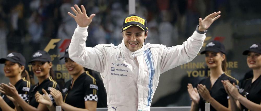 (FILES) This file photo taken on November 23, 2014 shows Williams&amp;apos; Brazilian driver Felipe Massa celebrating on the podium of the Yas Marina circuit in Abu Dhabi on November 23, 2014 after the Abu Dhabi Formula One Grand Prix.Massa is to retire definitively from Formula One at the end of the season he announced on November 4, 2017. The 36-year-old Williams pilot, who won 11 Grand Prix to date, decided to call it a day as his team are yet to confirm their line-up for next season. / AFP PHOTO / Karim SAHIB