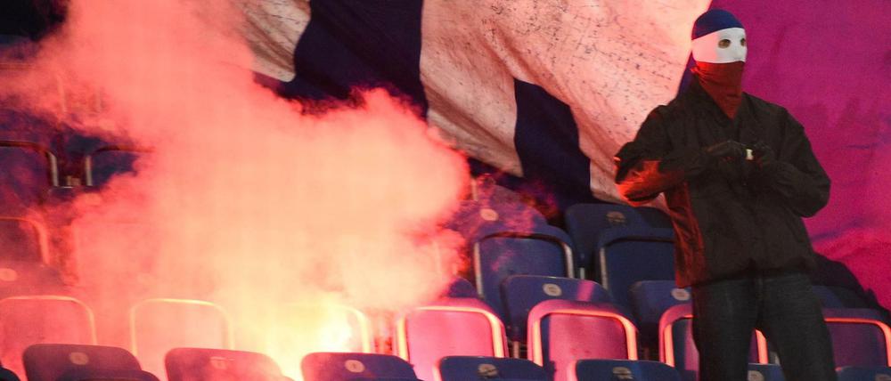 Rostocker Hooligans zünden Stadionsitze und einen Banner bei einem Spiel gegen Hertha BSC an. 