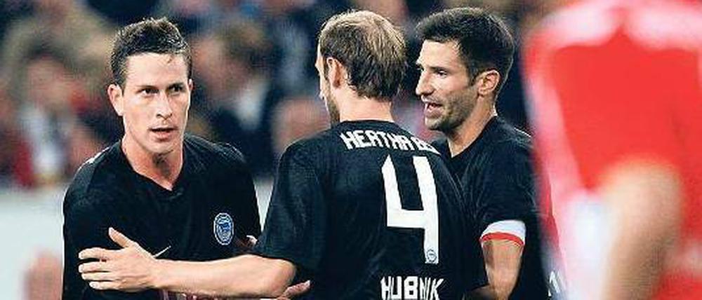 Glückwünsche im Vorbeigehen. Roman Hubnik (Mitte) und Andre Mijatovic herzen kurz Rob Friend (links), der Hertha in Düsseldorf in Führung schoss. Foto: dpa