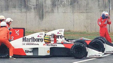 Sportsfreunde. McLaren-Pilot Alain Prost (r.) holt 1989 durch einen Crash mit dem Teamkollegen Ayrton Senna den Titel. Foto: AFP