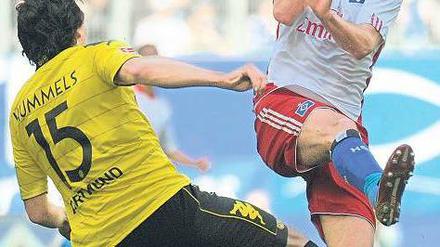 Augen zu und durch. Ruud van Nistelrooy (r.) schoss zwar die Hamburger in Führung, konnte aber Mats Hummels’ Dortmunder am Ende nicht besiegen. Foto: dpa