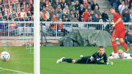 Gewinner steht, Verlierer liegt. Mario Gomez erzielt das 2:0 für den FC Bayern, Hannovers Torwart Ron-Robert Zieler hat das Nachsehen. Foto: Reuters