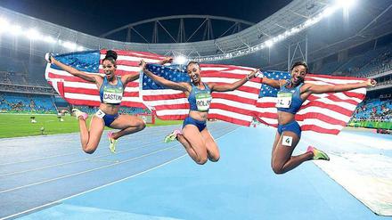 So haben es die US-Amerikaner am liebsten. Gold, Silber und Bronze für ihre Athleten. Hier feiern die 100-Meter-Hürdensprinterinnen Kristi Castlin (l.), Brianna Rollins und Nia Ali (r.) ihren Dreifachtriumph mit voller Beflaggung. 