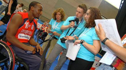 Benjamin Scholz und Alisha Mathis, Schülerreporter der "Paralympics Zeitung" interviewen den Rollstuhlbasketspieler Abdillah Jama (GBR).