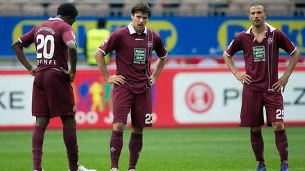 Kaiserslauterns Rodnei (l.), Florian Dick (mi.) und Anthar Yahia (r.) versuchen, den bevorstehenden Abstieg zu verarbeiten.