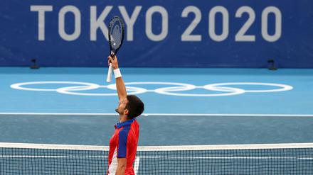 Novak Djokovic jubelt vor dem omnipräsenten Logo der Olympischen Spiele.