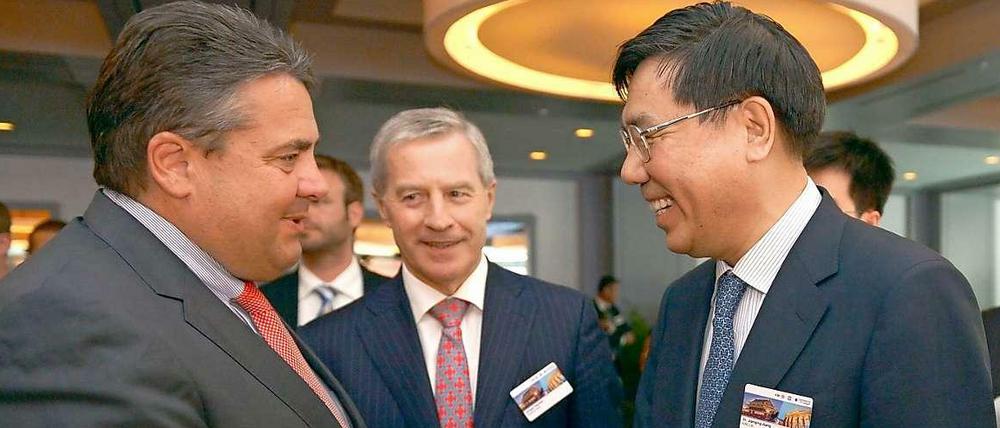 Minister Gabriel begrüßt den chinesischen Bankchef Jiang Jianquing.