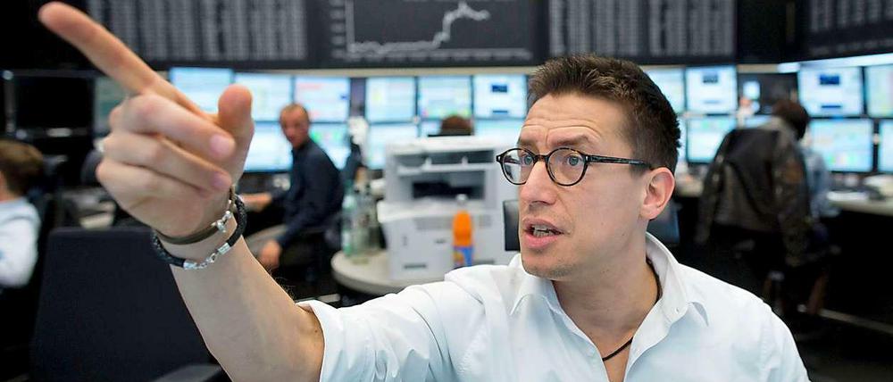 Ein Händler in der Frankfurter Börsen deutet mit dem ausgestreckten Zeigefinger auf einen Punkt. 