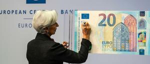 Christine Lagarde, die neue Präsidentin der Europäischen Zentralbank (EZB), unterschreibt symbolisch einen übergroßen 20-Euro-Schein. 