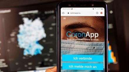 Die freiwilige Corona-App mit der Webseite des Robert Koch Instituts dahinter.