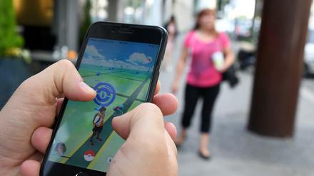 Aufs Handy konzentriert statt auf die Straße: Der ADAC warnt Pokémon-Go-Spieler vor Gefahren. 