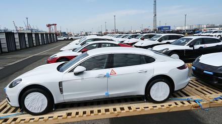 Fahrzeuge von Porsche stehen vor ihrer Verladung in Container in Bremerhaven auf Paletten. 