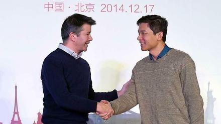 Die Chefs von Uber (links) und Baidu arbeiten künftig enger zusammen.
