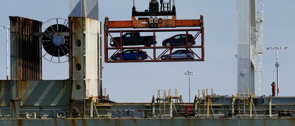 Ein Kran hebt Autos über ein Containerschiff im Hafen von Oakland. 