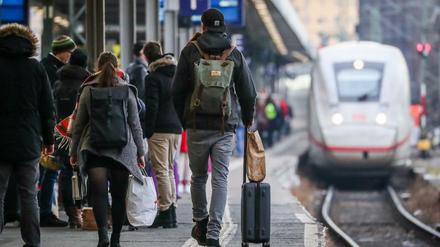Fahrgäste warten am Stuttgarter Hauptbahnhof auf die Einfahrt eines ICE-Zuges mit Fahrtziel München.