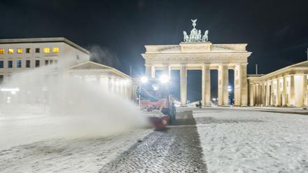 Ein Schneeräumfahrzeug vor dem Brandenburger Tor.