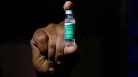 FILE PHOTO: A man displays a vial AstraZeneca's COVISHIELD vaccine as the country receives its first batch of coronavirus disease (COVID-19) vaccines under COVAX scheme, in Accra, Ghana February 24, 2021. REUTERS/Francis Kokoroko/File Photo