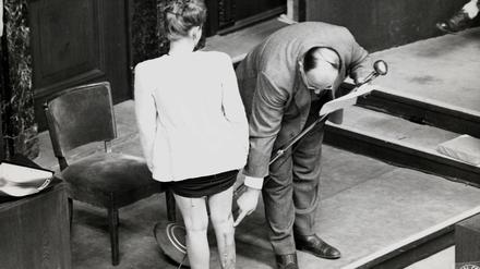 Leo Alexander demonstriert an einer der polnischen Frauen, die in Nürnberg als Zeugin auftraten, Taten der NS-Ärzte.