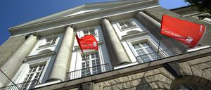 Fassade eines Universitätsgebäudes mit roten Fahnen und Aufschrift Universität der Künste.