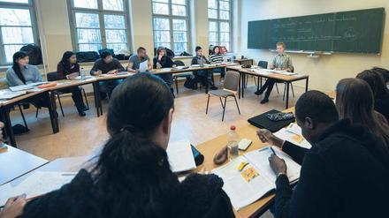 Geflüchtete lernen in einem Volkshochschulkurs in Berlin Mitte Deutsch.