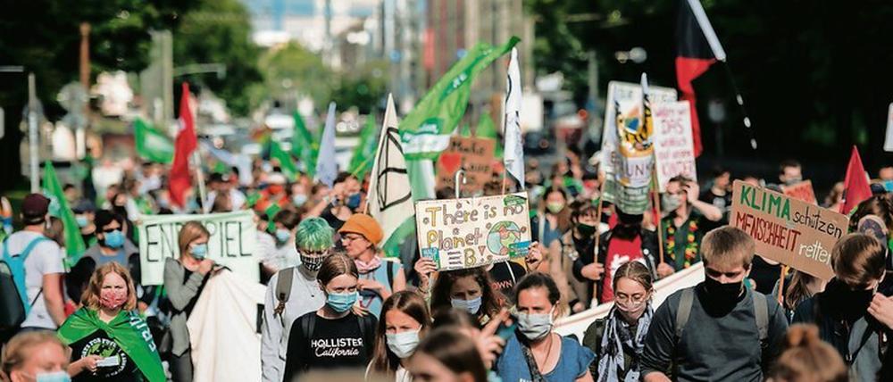 Junge Menschen mit Transparenten und Plakaten auf einer Demonstration für mehr Klimaschutz