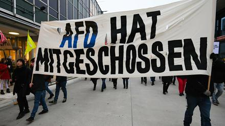 Wenn Hetze mittelbar Gewalt hervorruft. Teilnehmer einer Demonstration halten im Anschluss an den rassitischen Terroranschlag in Hanau ein Banner mit der Aufschrift "AFD hat mitgeschossen" in die Höhe.