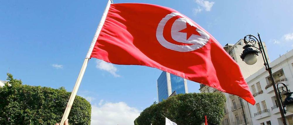 Aktivisten der Ennahda-Partei schwenken Tunesiens Flagge.